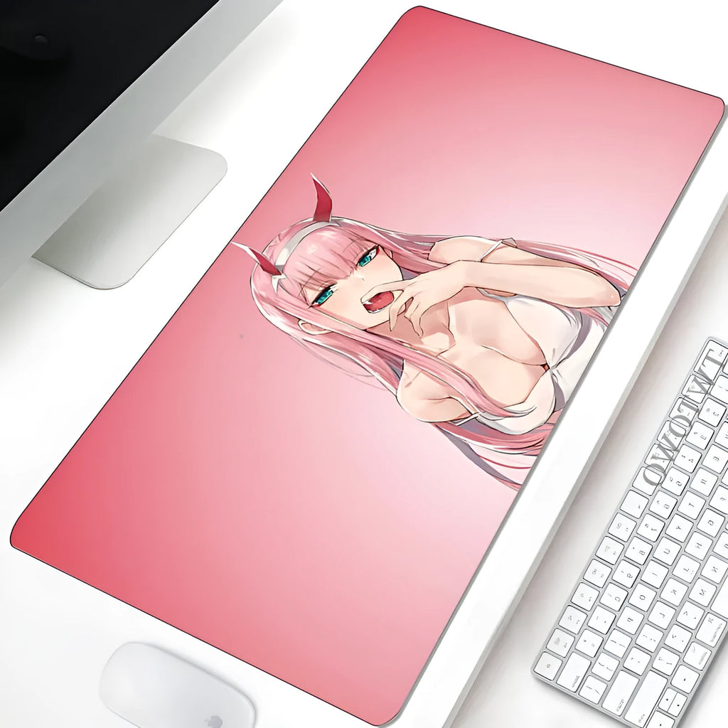 Pink cloth keyboard mat with Darling in the Franxx anime print on a desk