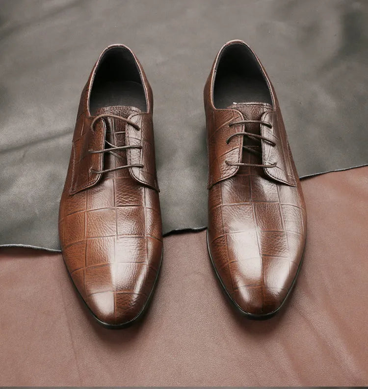 Men's black handcrafted leather derby shoes with a pointed toe and rubber sole.