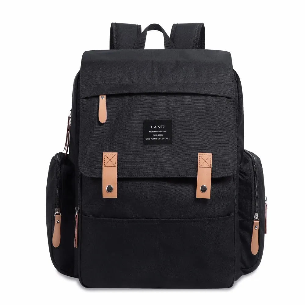 LAND Mommy large grey diaper backpack with multiple compartments and a changing mat laid out