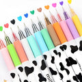 Box of 12 cow colour gel pens with 0.38mm fine tips on a desk.