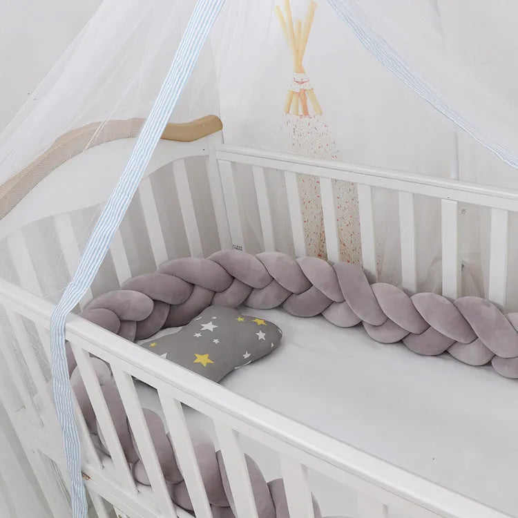 Multi-colour baby crib bumper made of spandex velvet, shown bent around a crib edge.