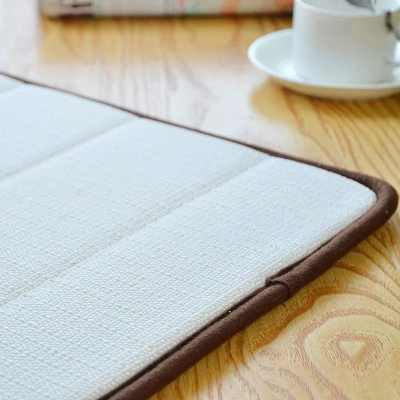 Coral fleece non-slip bath mat in 40x60cm size, placed on bathroom floor with water absorbent surface