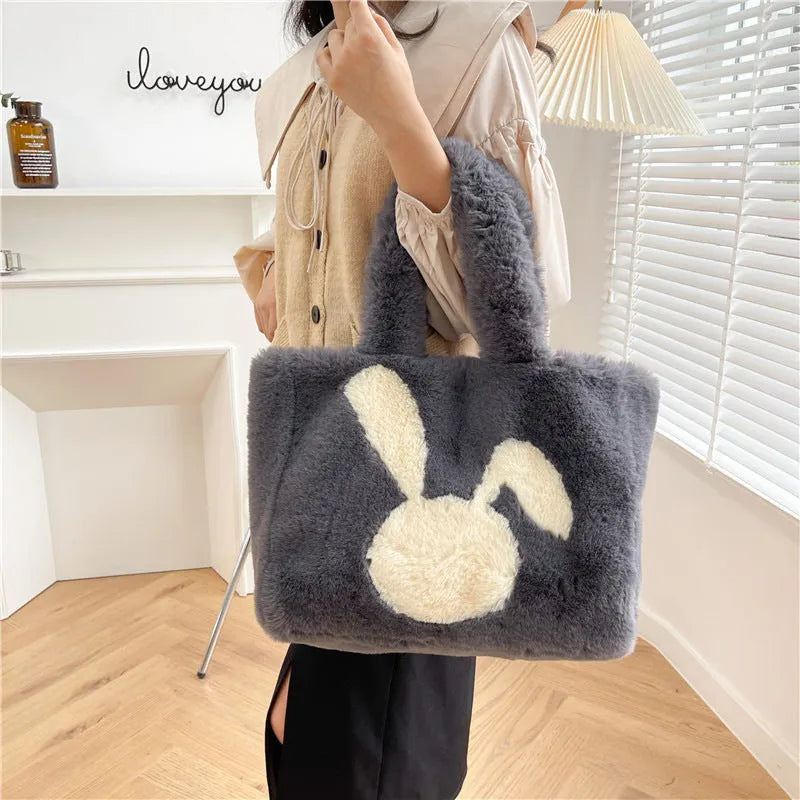 Cute cartoon rabbit ears plush shoulder tote bag in a solid colour.