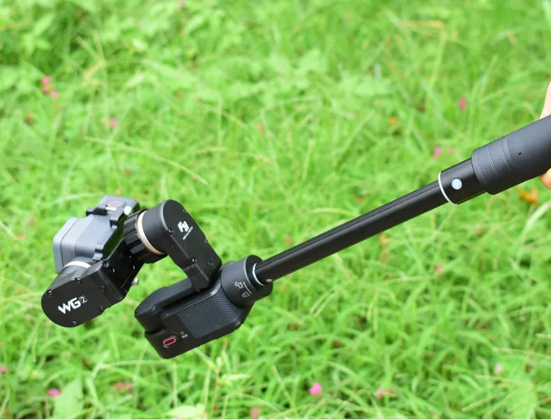 Black retractable metal selfie stick with hand-held stabilizer extended for smartphone photography