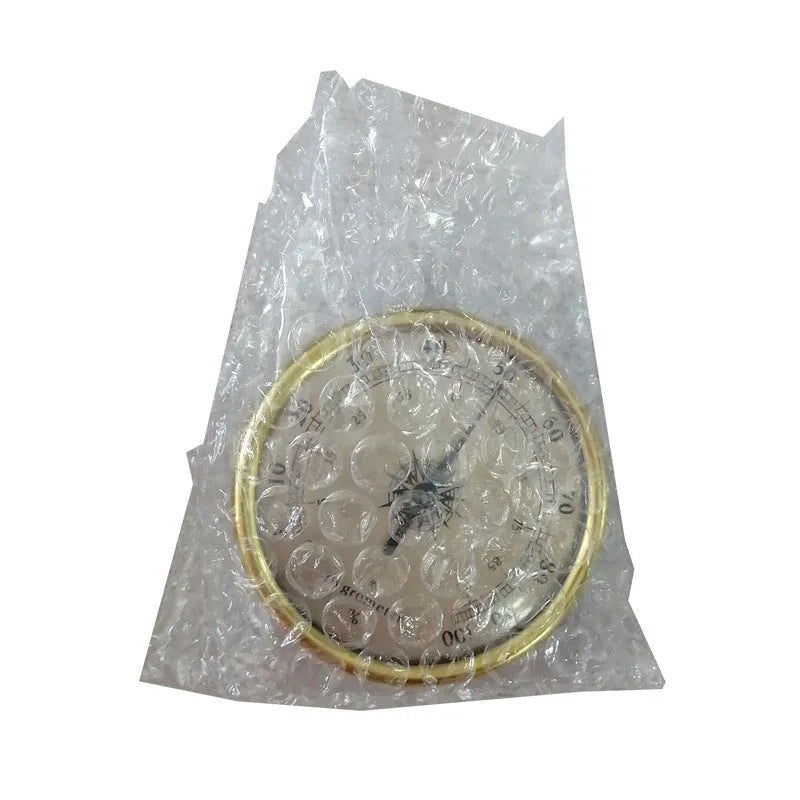 Circular analogue thermometer and hygrometer with aluminium outer ring and dial showing temperature and humidity scales