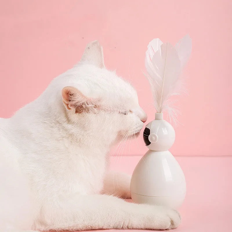 Tumbler cat toy in white with three replacement feathers on a light background