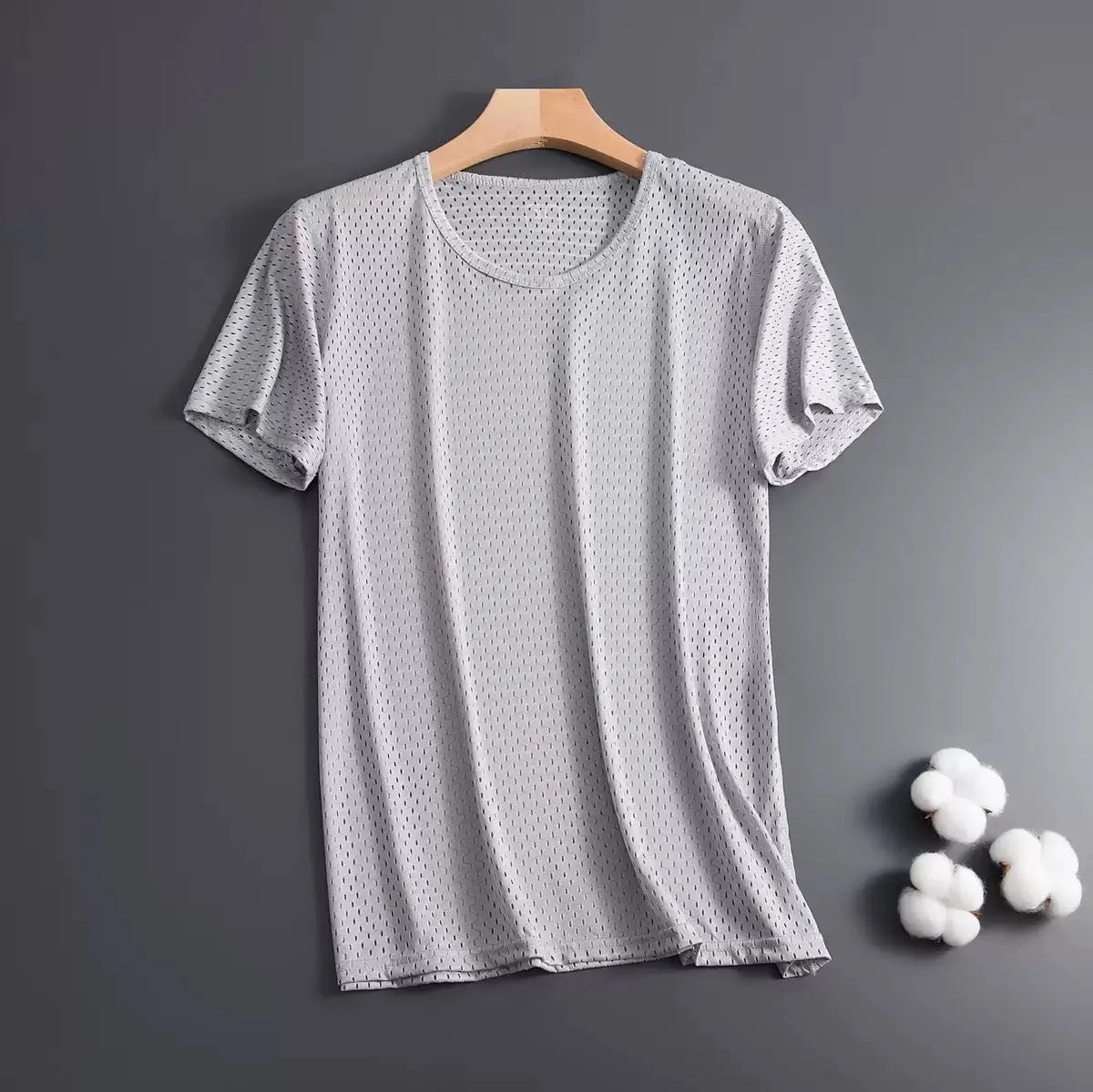 Men's solid colour ice silk short sleeve t-shirt on a hanger, showing loose crew neck and thin mesh fabric.
