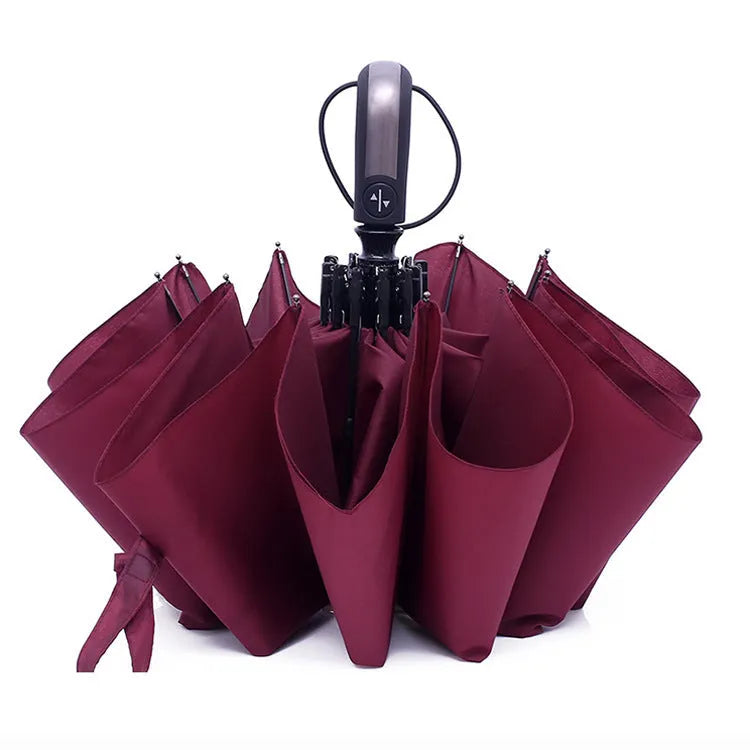 Black triple folding automatic business umbrella with 10 ribs and a rubber handle, shown open.