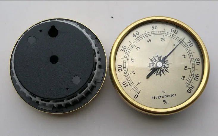 Circular analogue thermometer and hygrometer with aluminium outer ring and dial showing temperature and humidity scales