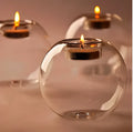 Hand-blown Europe style hollow glass candle holder in round design on table