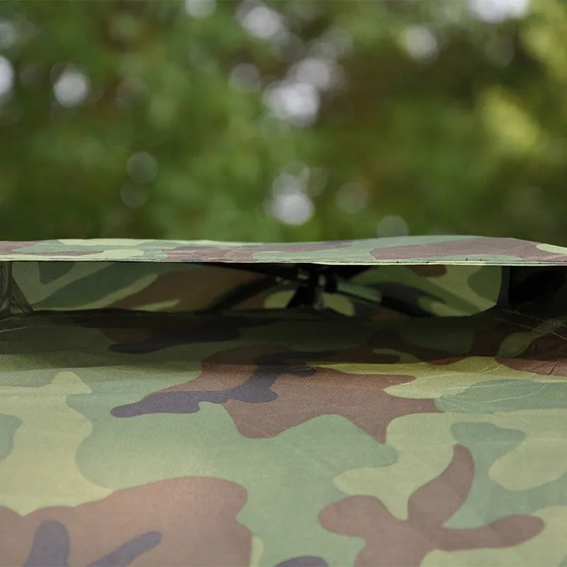 Green digital camouflage outdoor tent with fibreglass poles setup in woodland environment