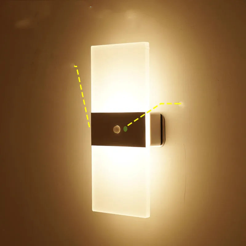 Magnetic rechargeable wall lamp in arc style, black finish, with warm light on a metal bedside shelf