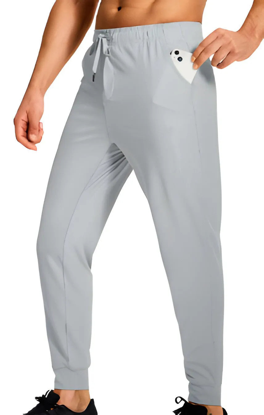 Men's solid colour loose casual trousers in polyester fabric on a hanger.