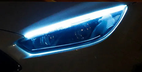 Flexible silicone car LED daytime running light strip with flowing turn signal functionality mounted on vehicle headlight