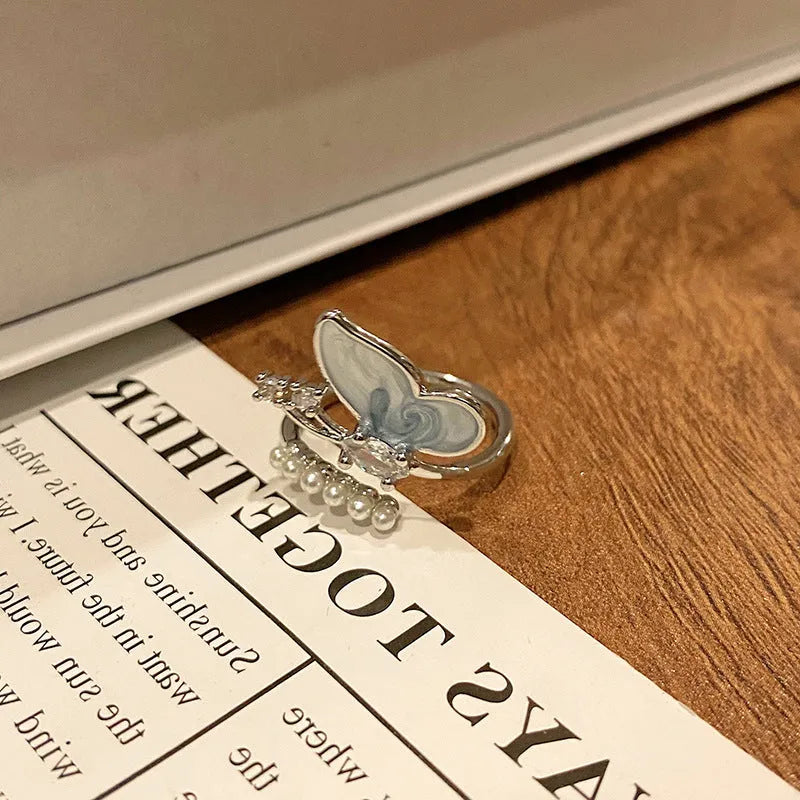 Copper butterfly women's ring with oil-drip finish showing open-loop design