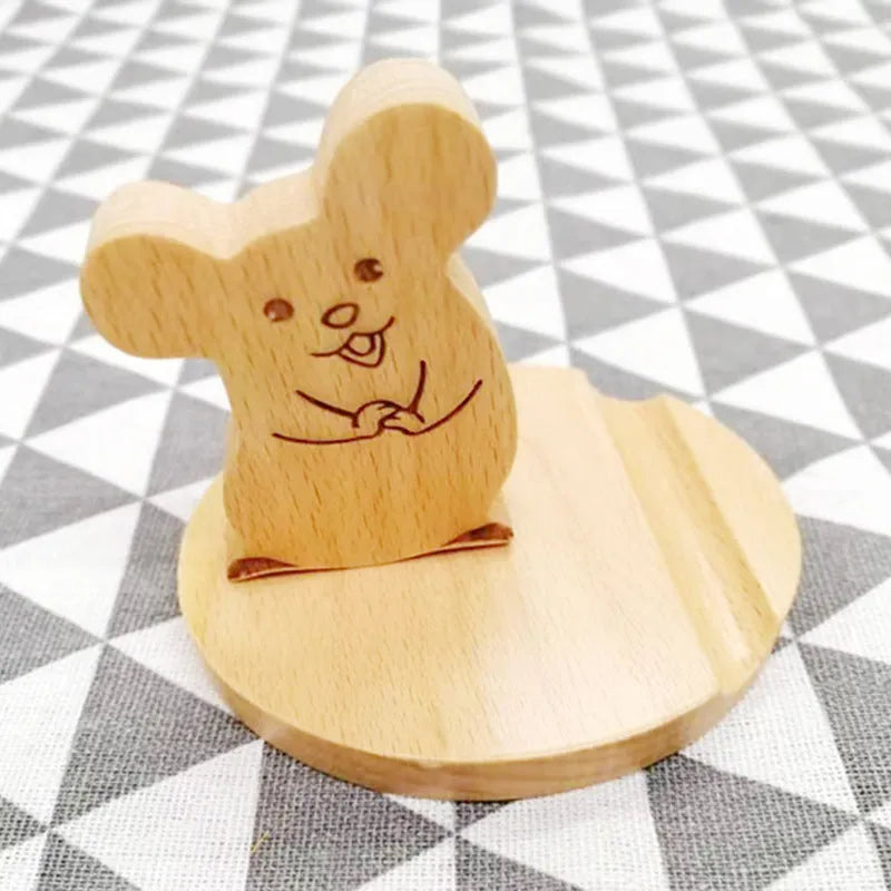 Decorative resin mobile phone stand in a choice of styles including animal figures and wood-effect designs.
