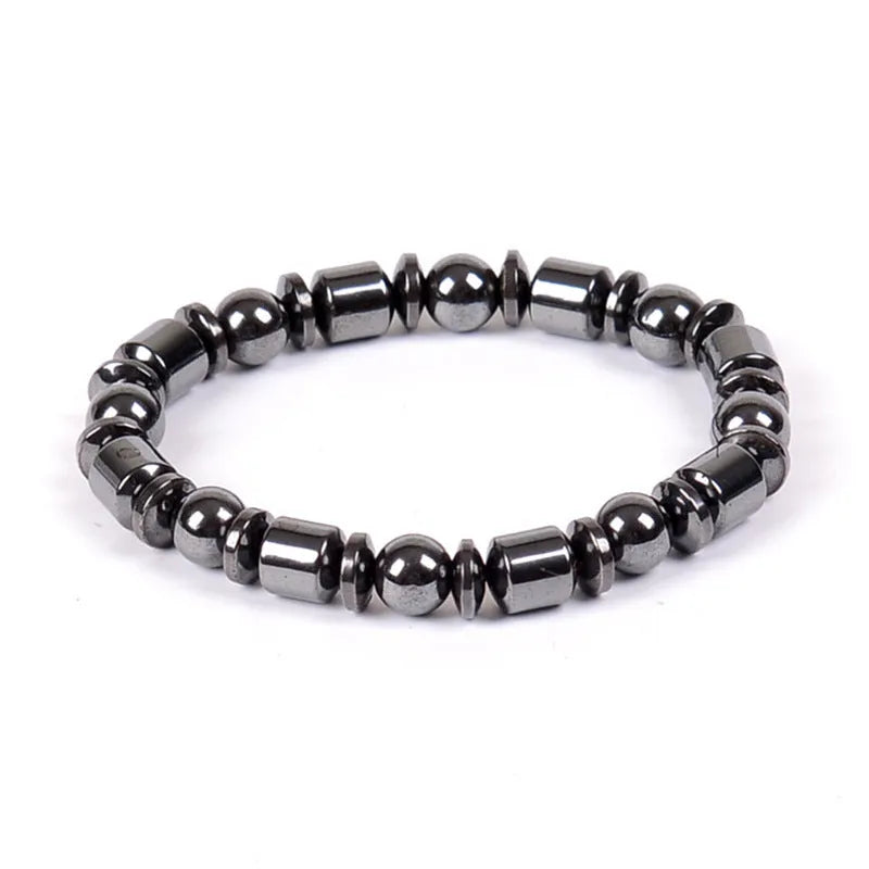 Black pentagram design magnetic therapy bracelet made from magnetite and hematite stones on a wrist.