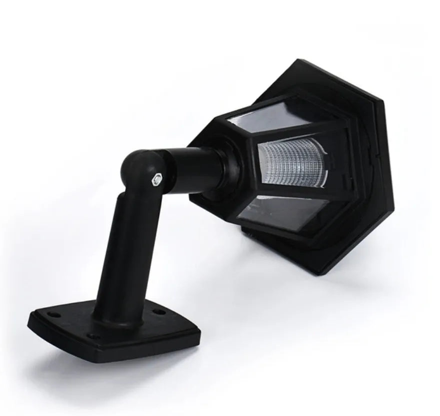 Black hexagonal solar-powered outdoor wall light with a visible solar panel and LED.