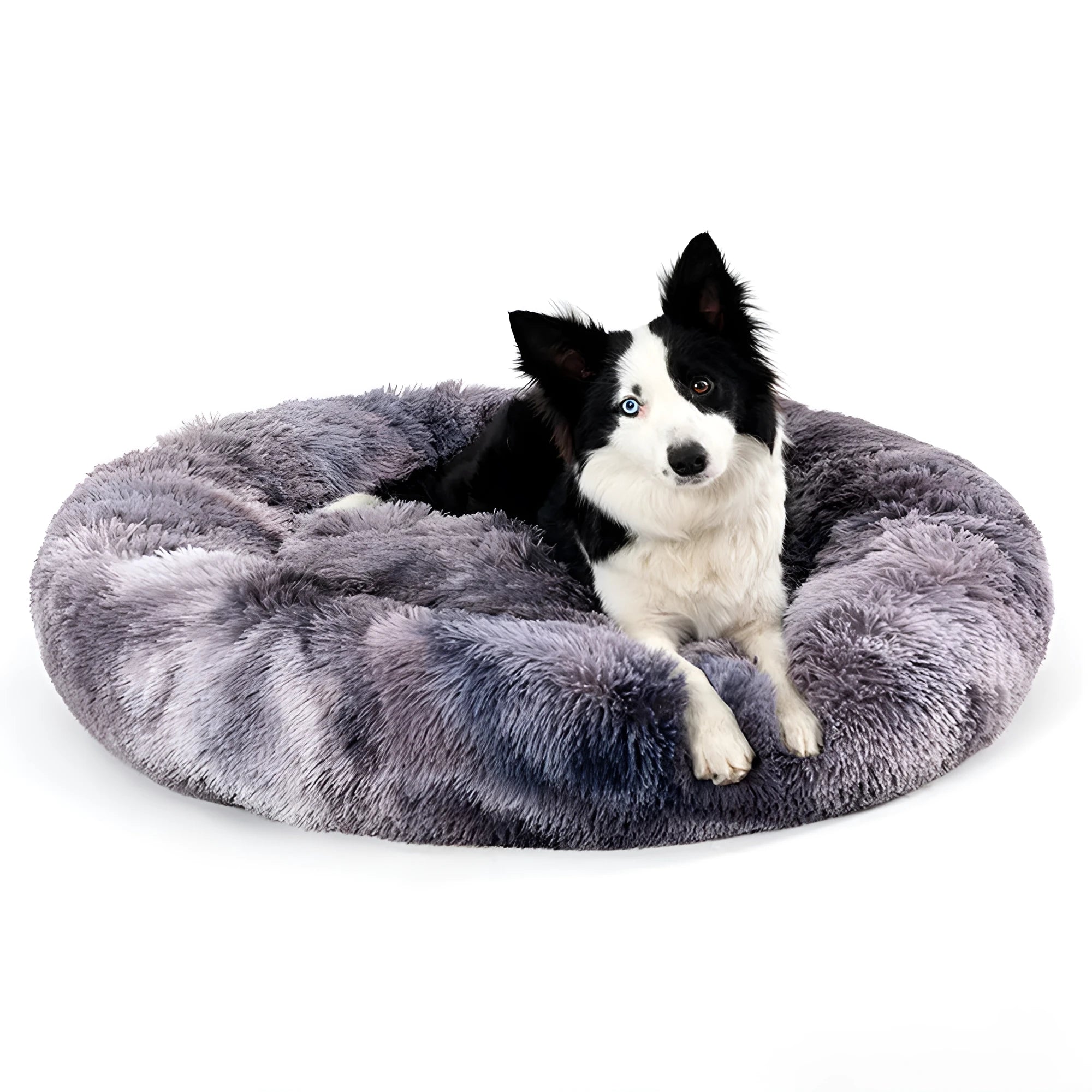 Fluffy donut-shaped dog bed in long plush material, shown in a light grey colour.