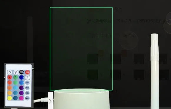 Black 3D acrylic LED message board night light with remote control and pen on desk