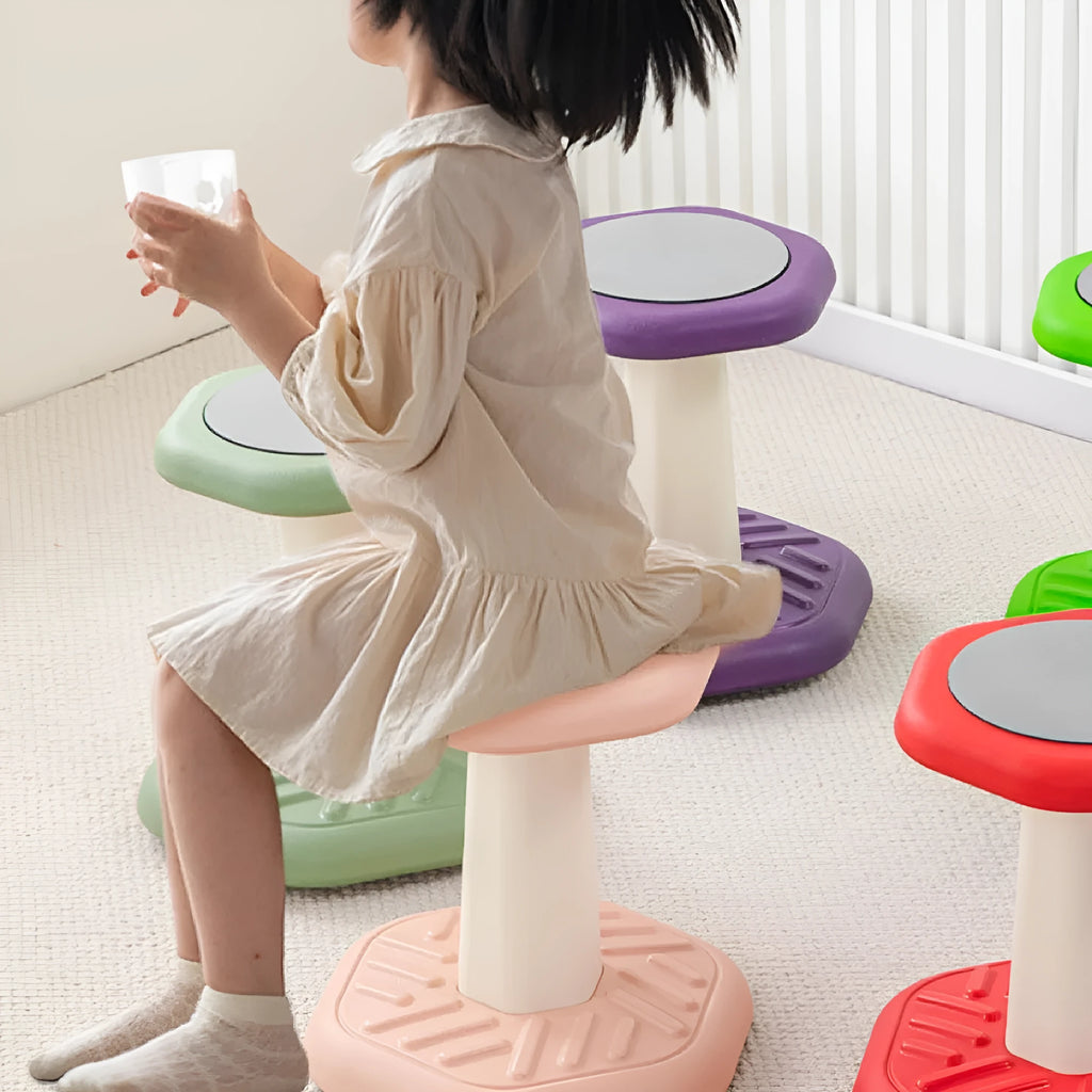 Children's multi-action plastic rocking stool available in black, blue, green, pink, purple, and red for balance training.