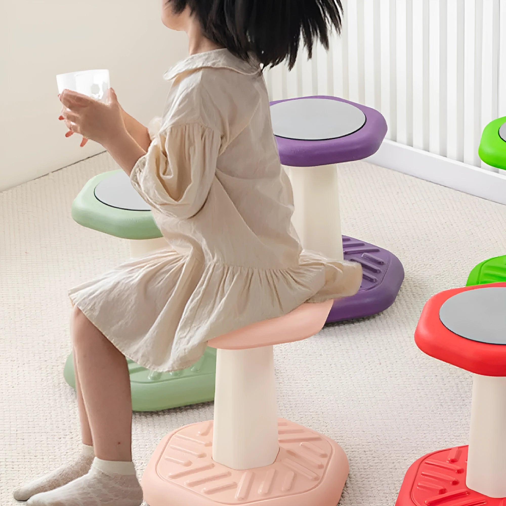 Children's multi-action plastic rocking stool available in black, blue, green, pink, purple, and red for balance training.