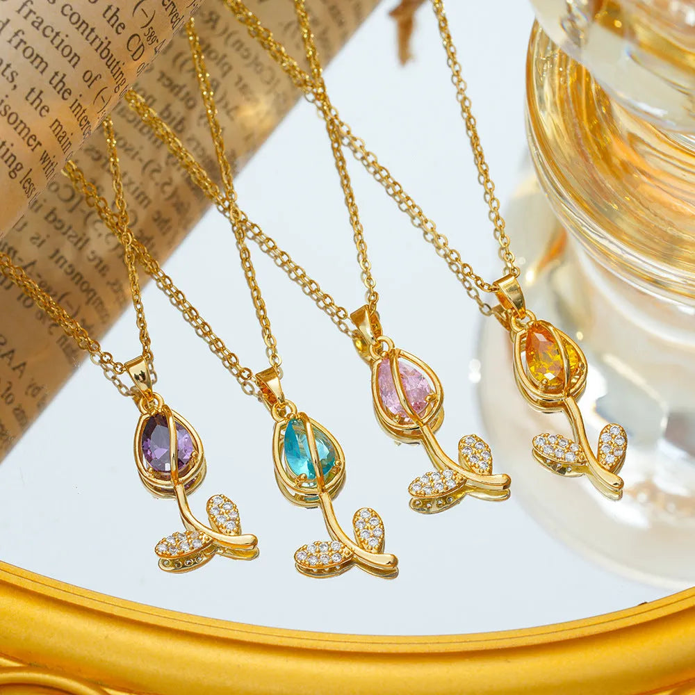 Gold-coloured zircon tulip pendant necklace on an adjustable O-ring chain, shown in pink, yellow, purple, green, and white colour variations.
