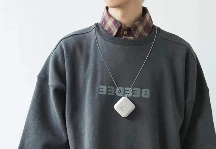 Mini USB portable air purifier necklace worn as a collar, showing pink and blue colour options.