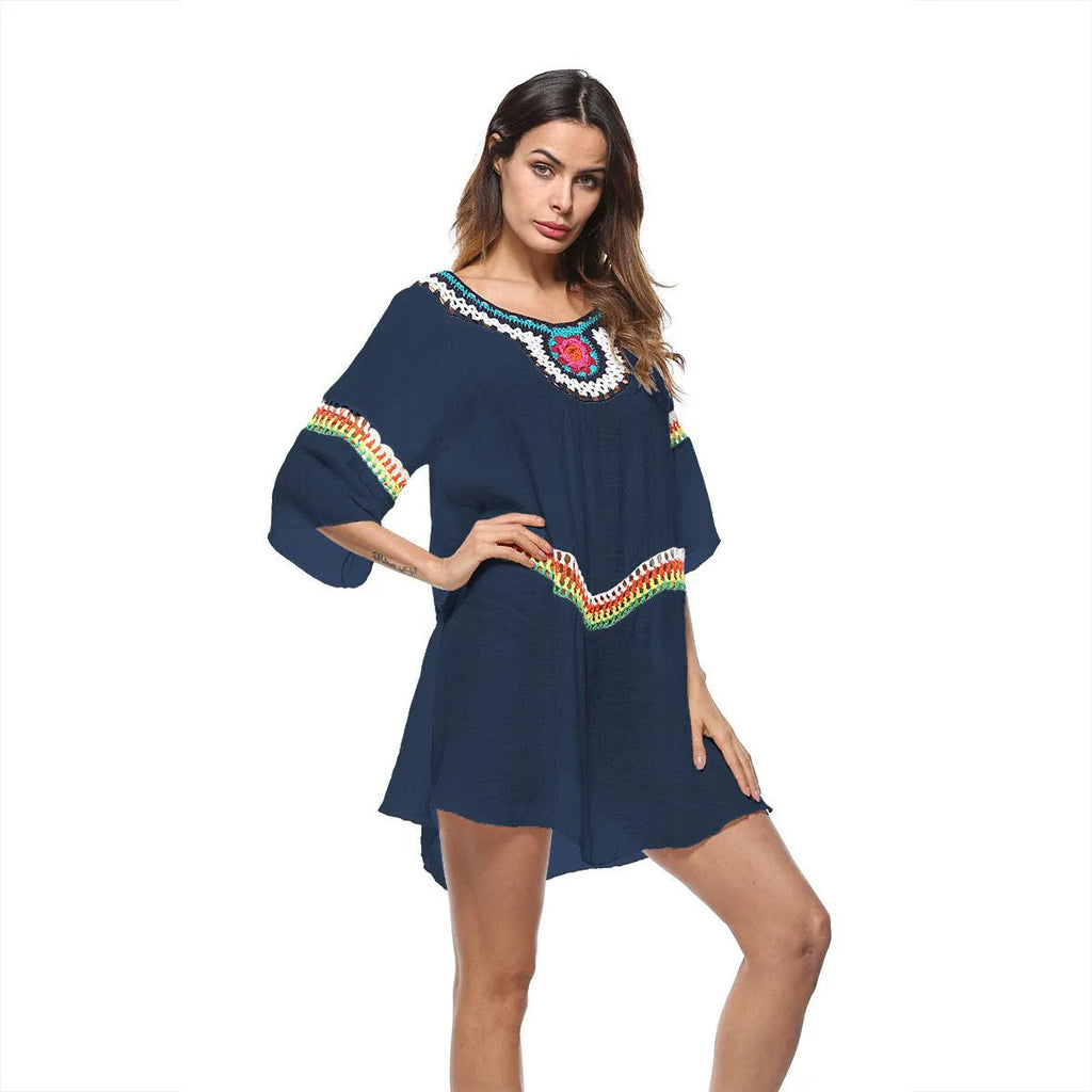 Women's crocheted white beach cover-up top for sun protection during swimming.