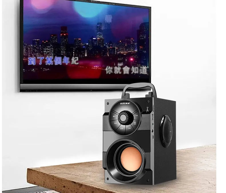 Black portable mini home audio system with subwoofer showing 3.5mm audio cable and USB power connection