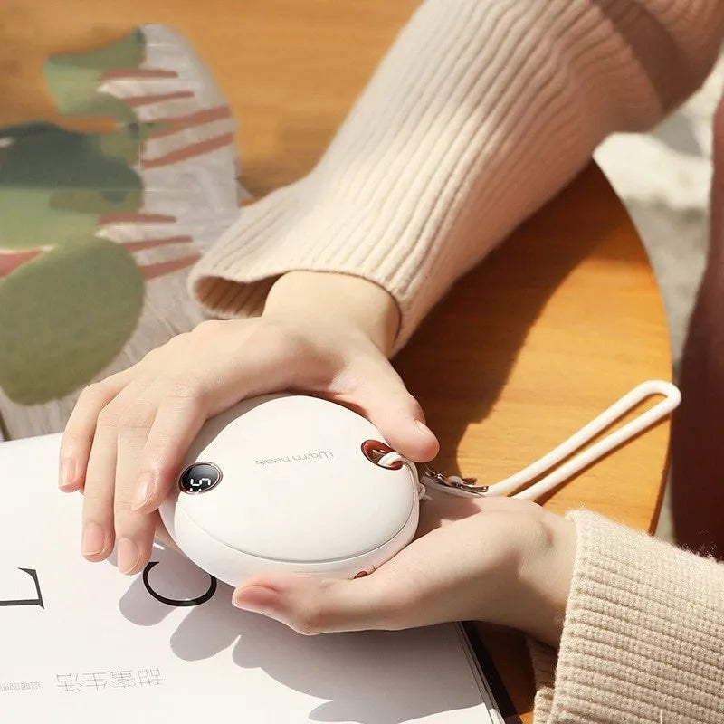 Green hand warmer power bank with digital display showing charge level, measuring 89.5mm square