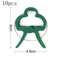 Green plastic and zinc plant fixing clips for supporting tomato vines and climbing plants in the garden.