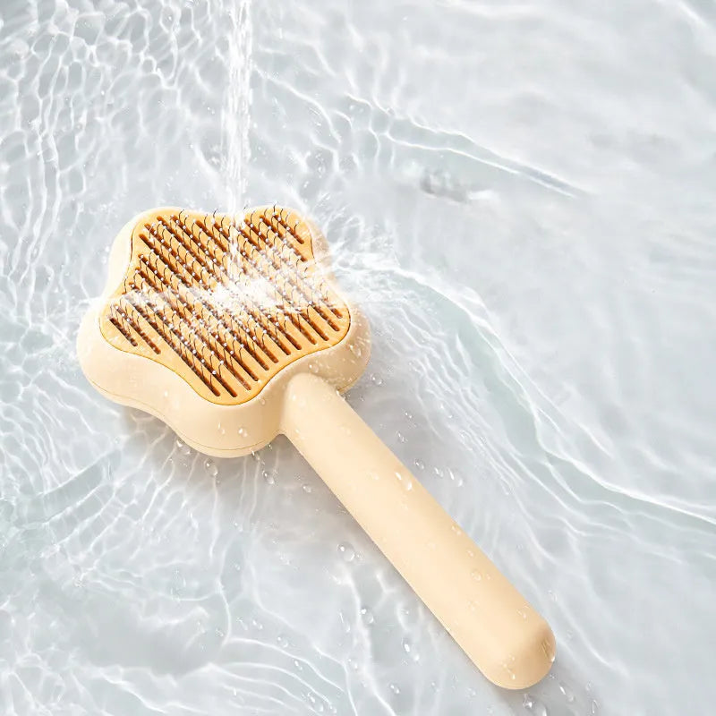 Green self-cleaning cat comb with stainless steel needles and retraction button