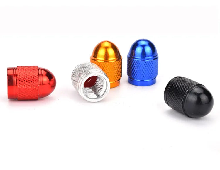Aluminium mountain bike tyre valve dust cap in gold, red, silver, blue, and black colours.