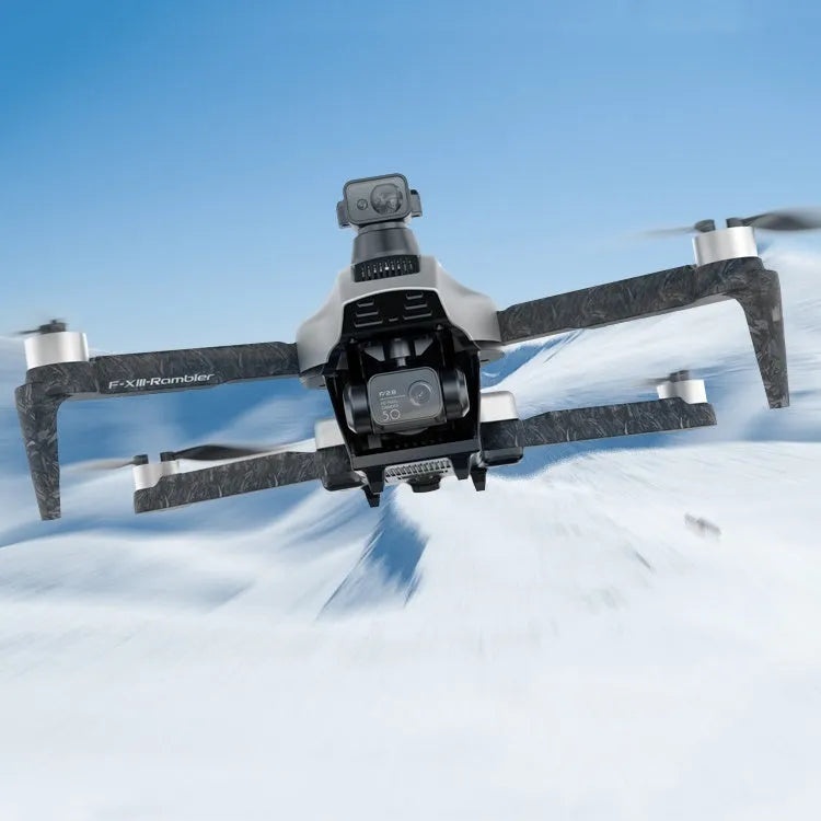 White folding quadcopter drone with camera, shown collapsed next to its remote control and shoulder bag.