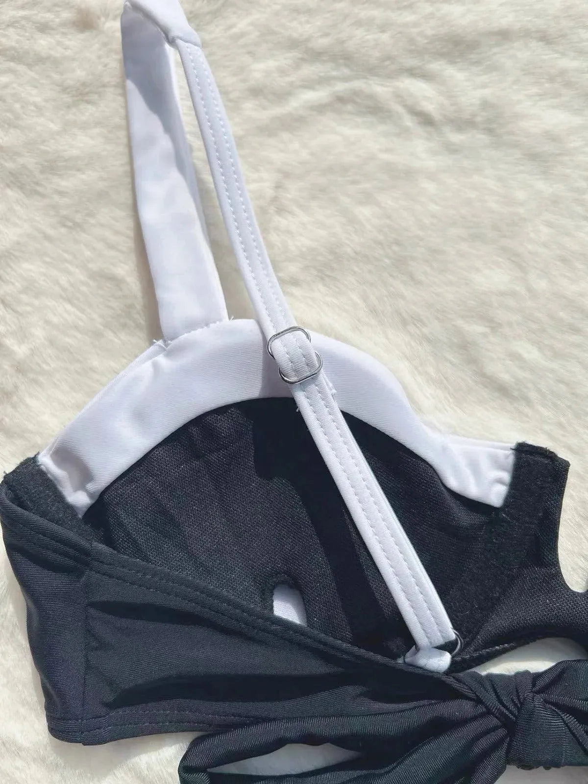 Black women's low-waist bikini swimsuit with stitch detailing and split briefs.