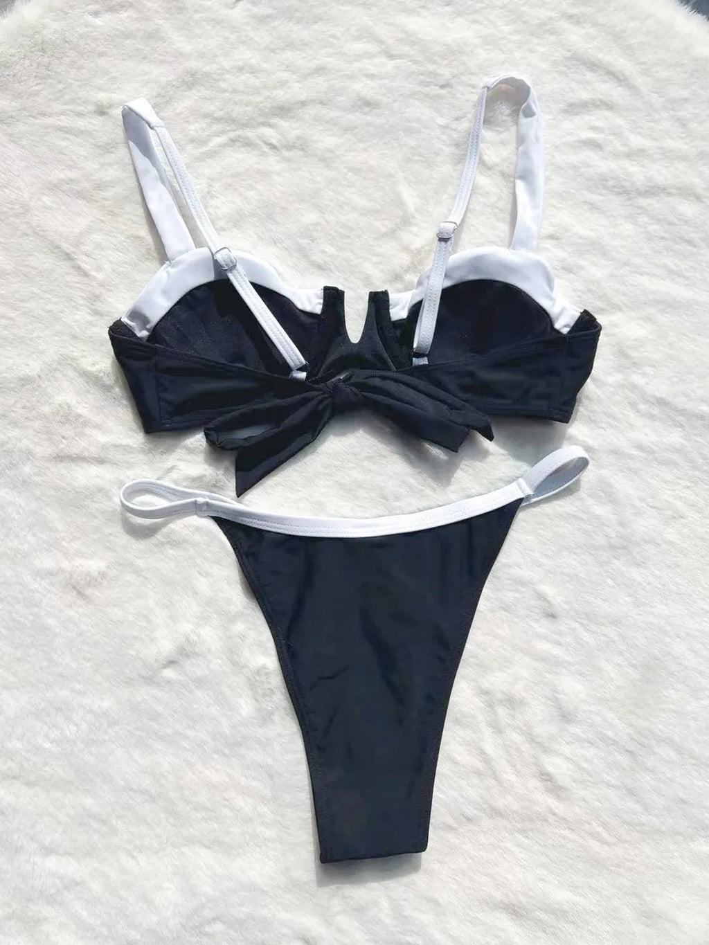 Black women's low-waist bikini swimsuit with stitch detailing and split briefs.