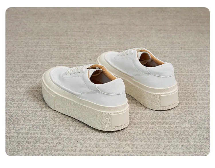 Women's black platform sports board shoes made from embossed cowhide leather with a rubber sole.