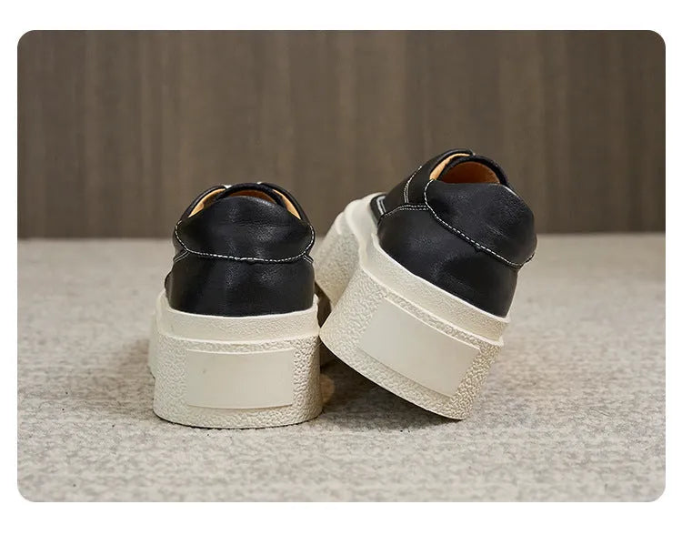 Women's black platform sports board shoes made from embossed cowhide leather with a rubber sole.