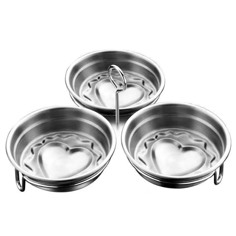 Mini stainless steel egg steamer showing both round and heart-shaped design options on a kitchen counter.