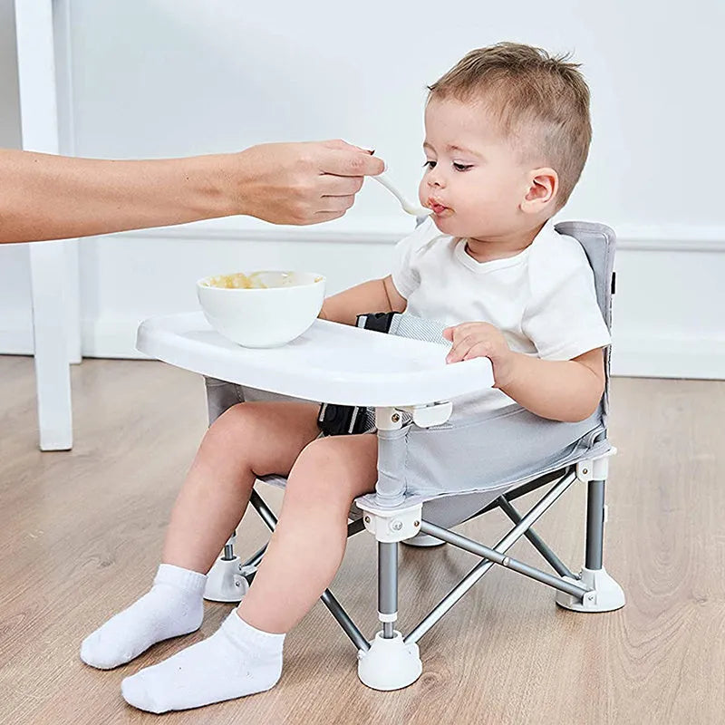 Foldable baby dining chair with metal frame, removable tray, and safety belt in grey