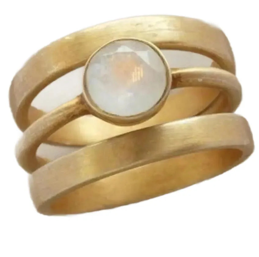 Gold titanium steel geometric ring with micro-inlaid white chalcedony stones on a hollow band.