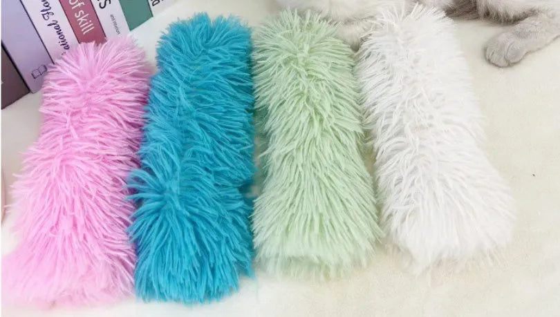 Blue, green, pink, and white plush cat toy pillow measuring 27cm by 10cm.