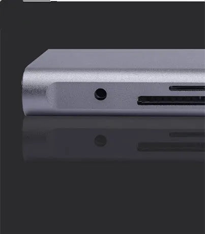 Silver 10-in-1 USB-C docking hub for MacBook with multiple ports including HDMI, USB, and SD card slots.