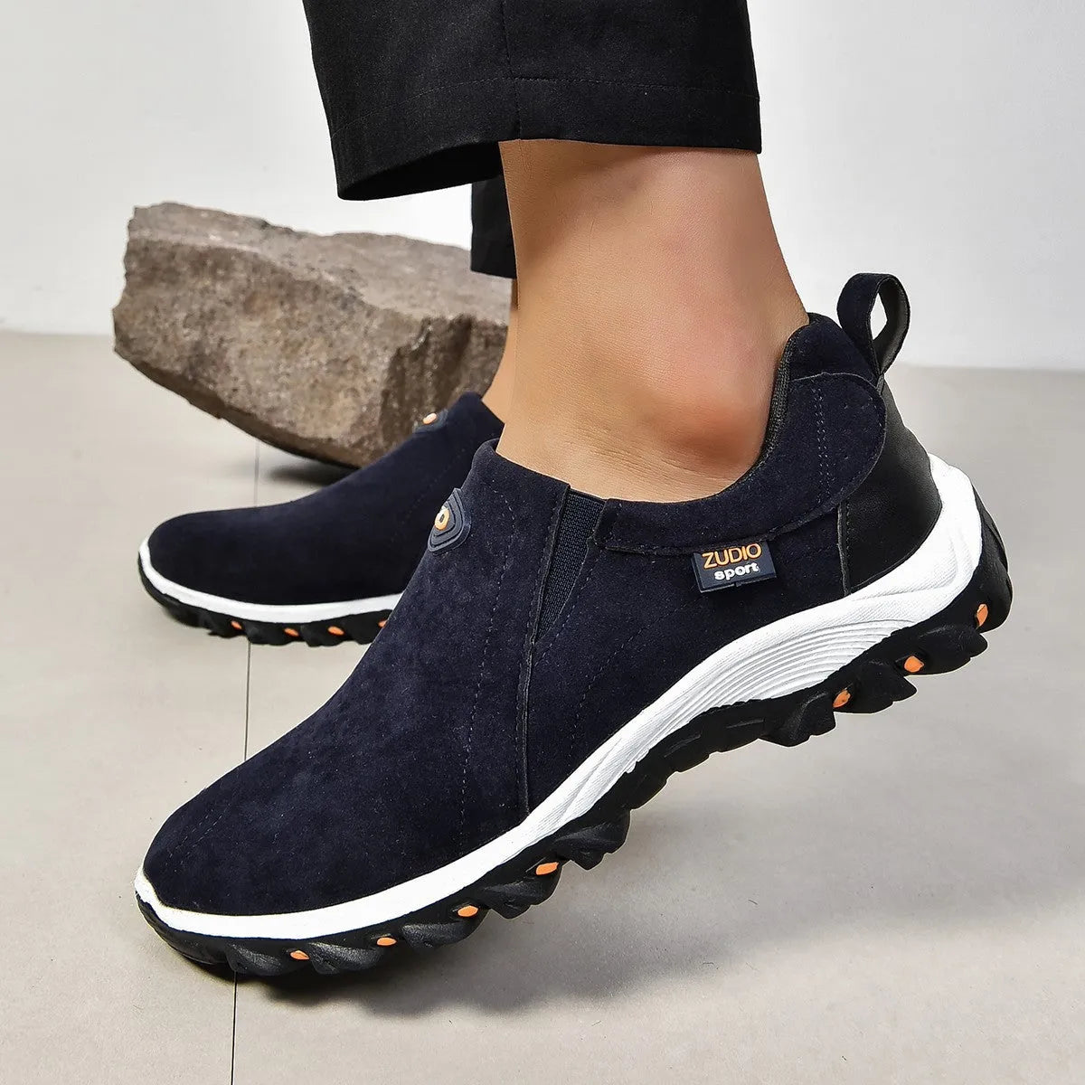 Men's black elastic slip-on shoe covers with round toe and rubber sole, showing PU upper material.