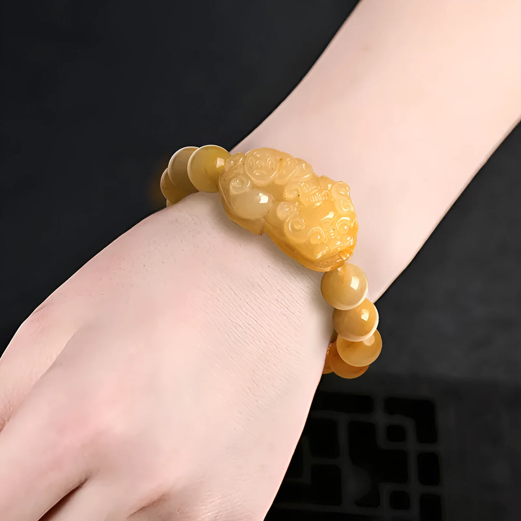 Personalised carved Golden Thread Jade bracelet showing bead detail and size comparison.
