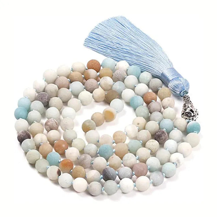 Long geometric agate and gemstone tassel necklace with blue, purple, and multi-coloured beads on a black background.