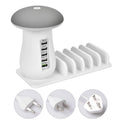 White mushroom-shaped LED desk lamp with 5 USB charging ports at its base on a wooden table.