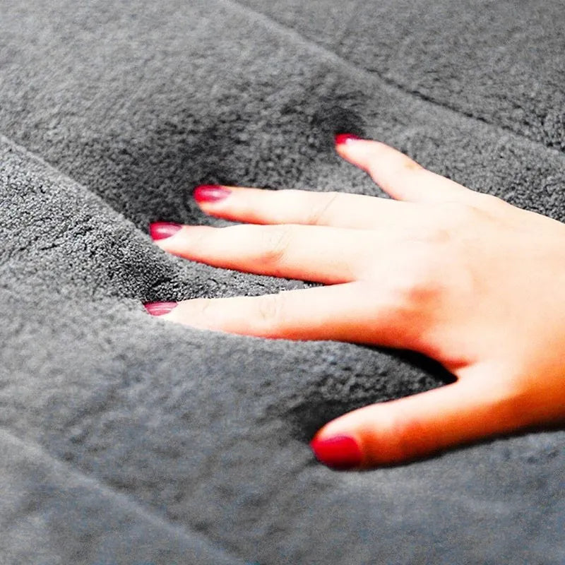 Coral fleece non-slip bath mat in 40x60cm size, placed on bathroom floor with water absorbent surface