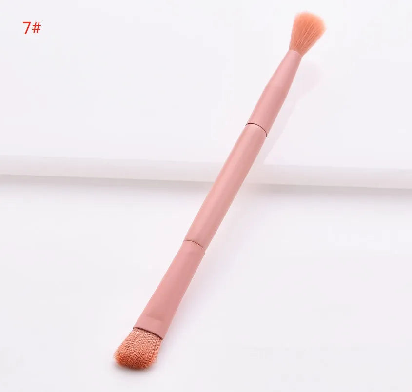 Ten professional makeup brushes with wooden handles arranged by size for different cosmetic applications